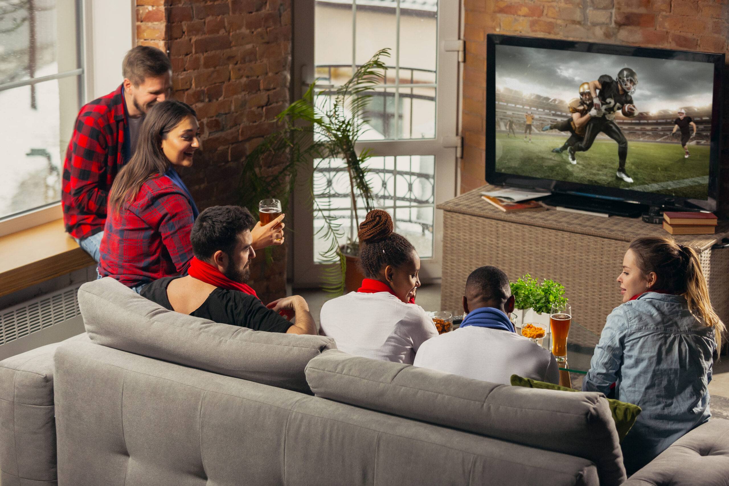 group of friends watching rugby game